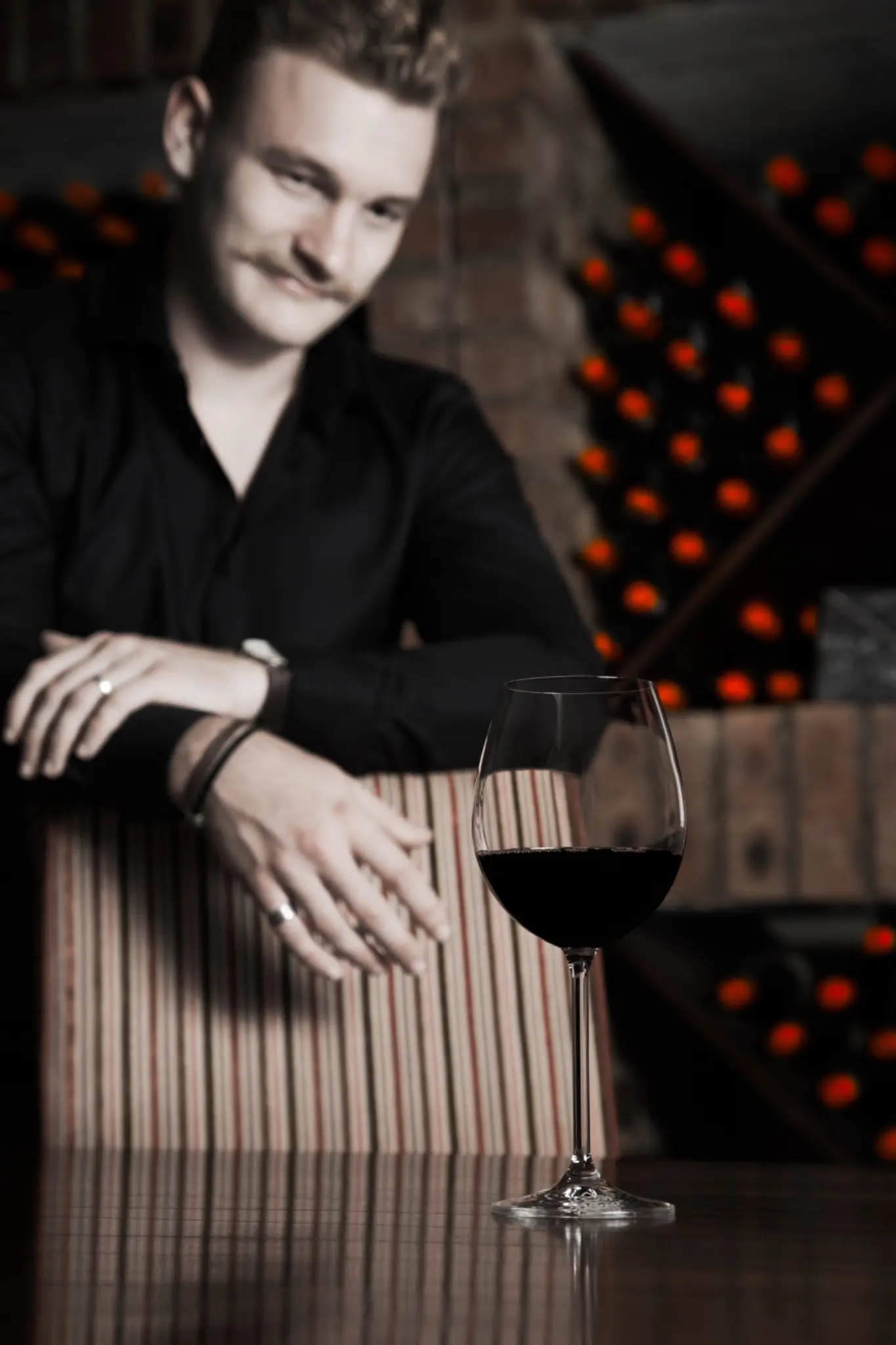 A guest enjoying a glass of red wine in the Ormonde Wines cellar